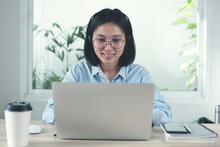Asian Business Woman Making Facetime Video Conference Via Laptop Computer Using Zoom Online Meeting App. Female Student Learning Online From Home 