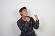© Irham Ghani Rizki - Asian man wearing black shirt is celebrating