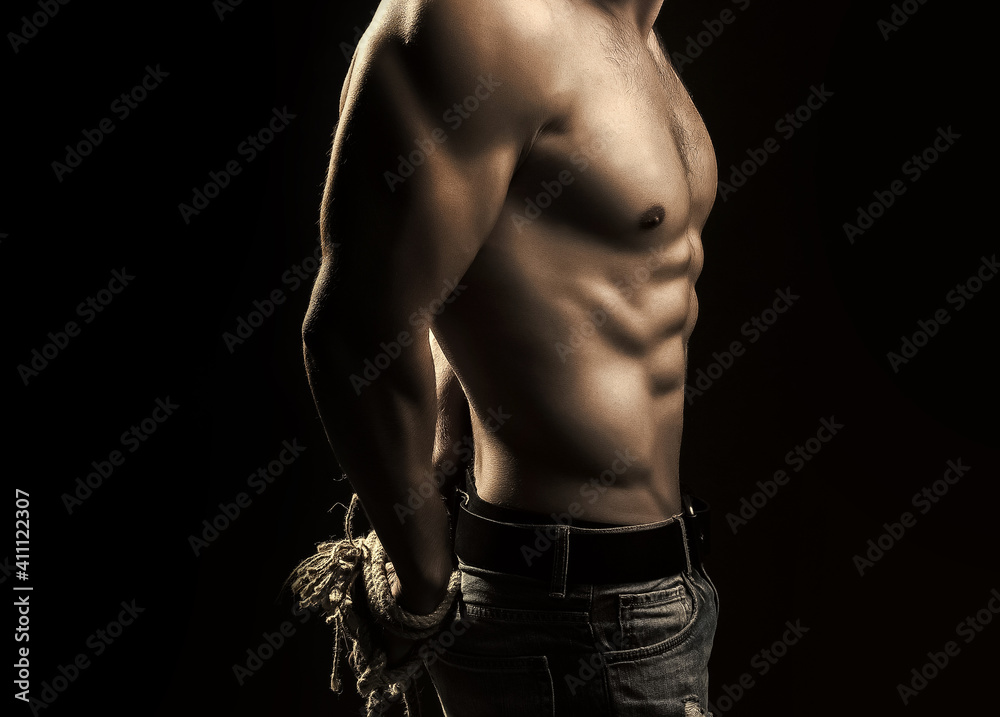 Sexy man with muscular body with tied hands by rope. - obrazy, fototapety, plakaty 
