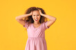 © Pixel-Shot - Stressed pregnant African-American woman on color background