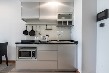 Microwave and kitchen equipment in the apartment