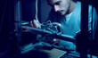 © StockPhotoPro - Young engineer working on a 3D printer