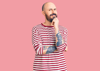 Canvas Print - Young handsome man wearing casual clothes looking confident at the camera with smile with crossed arms and hand raised on chin. thinking positive.