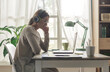 © StockPhotoPro - Young woman sitting at desk and watching videos online