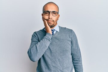 Poster - Hispanic adult man wearing glasses and business style touching mouth with hand with painful expression because of toothache or dental illness on teeth. dentist