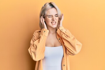 Canvas Print - Young blonde girl wearing casual clothes covering ears with fingers with annoyed expression for the noise of loud music. deaf concept.