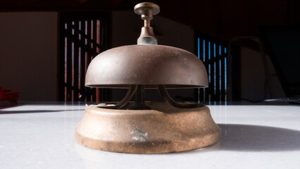 Old Rusty Reception Bell on marble countertop