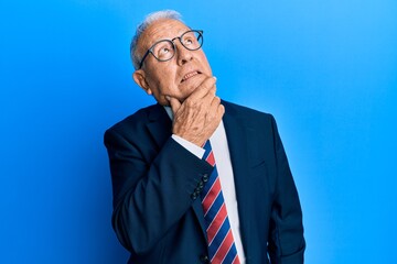 Poster - Senior caucasian man wearing business suit and tie thinking worried about a question, concerned and nervous with hand on chin