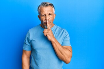 Sticker - Middle age grey-haired man wearing casual clothes asking to be quiet with finger on lips. silence and secret concept.