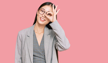 Sticker - Young chinese woman wearing business clothes smiling happy doing ok sign with hand on eye looking through fingers