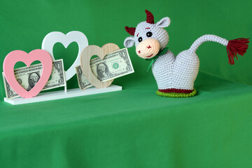 Wall Mural - Amigurumi doll gray bull on a background of hearts.