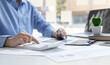 © Puwasit Inyavileart - Financial businessman calculating corporate income tax data And analyzing charts of financial stocks that are in good condition with growth and progress, Investment in finance and accounting.