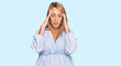 © Krakenimages.com - Beautiful blonde business woman wearing casual clothes suffering from headache desperate and stressed because pain and migraine. hands on head.