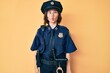 Young beautiful woman wearing police uniform making fish face with lips, crazy and comical gesture. funny expression.