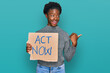 © Krakenimages.com - Young african american girl holding act now banner pointing thumb up to the side smiling happy with open mouth