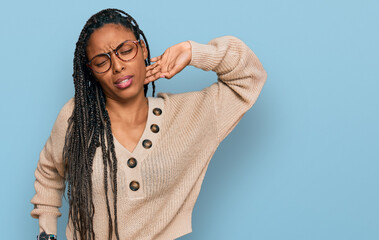 Wall Mural - African american woman wearing casual clothes stretching back, tired and relaxed, sleepy and yawning for early morning