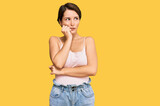 Fototapeta Panele - Young brunette woman with short hair wearing casual summer clothes looking stressed and nervous with hands on mouth biting nails. anxiety problem.