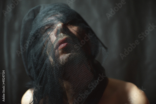 Close-up Of Man Wrapping Net Over Face At Home