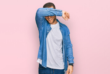 Wall Mural - Young caucasian man wearing casual clothes covering eyes with arm smiling cheerful and funny. blind concept.