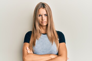 Wall Mural - Young blonde woman wearing casual clothes skeptic and nervous, disapproving expression on face with crossed arms. negative person.