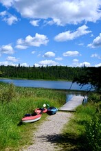 Three Kayaks On A Path To The Lake