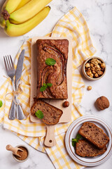 Wall Mural - Banana bread with walnuts, hazelnuts and cinnamon. Sweet homemade dessert. Top view