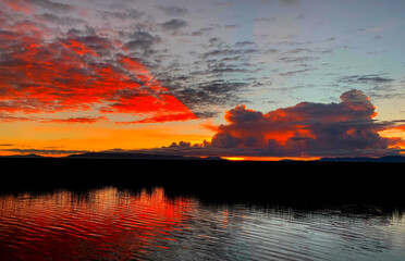 Wall Mural - Red sunset over Titicaca lake at night.