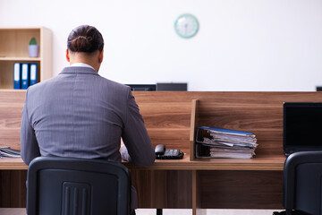 Young male employee working in the office