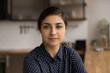 © fizkes - Profile picture of pretty millennial lady of indian ethnicity posing indoors at home in office. Head shot portrait of attractive mixed race woman with stylish makeup looking at camera shoot video blog