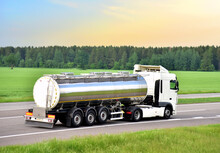 Isothermal Tank Truck Driving On Highway. Oil And Gas Transportation And Logistics. Metal Chrome Cistern Tanker With Petrochemicals Products. Liquid Chemical Freight. Soft Focus Possible Granularity