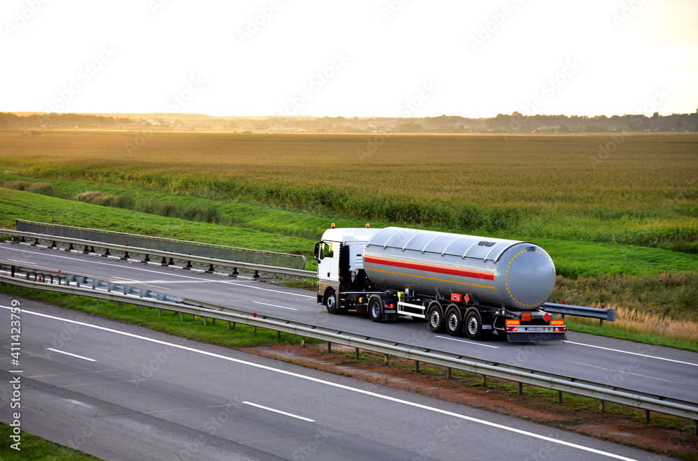 Tank truck driving on highway. Transportation of liquid goods. Metal ...