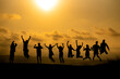 Silhouette Friends Jumping Against Sky During Sunset