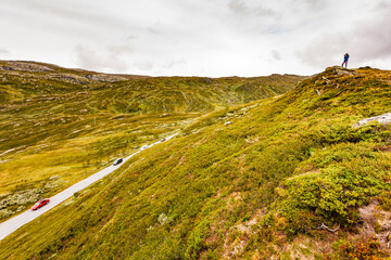 Canvas Print - Tourist with camera in Norway mountains