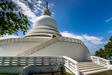 Part of a religious building close-up in Sri Lanka against a blue sky with white clouds