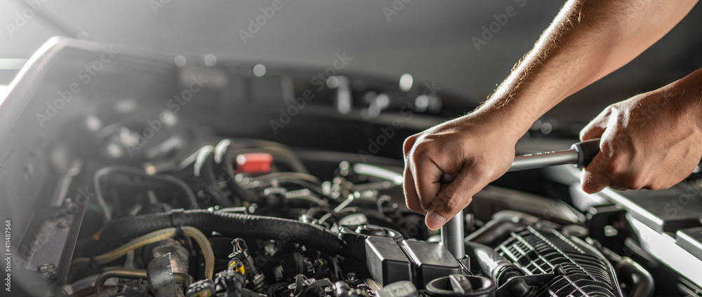 Auto mechanic working and repair on car engine in mechanics garage. Car service. - obrazy, fototapety, plakaty 