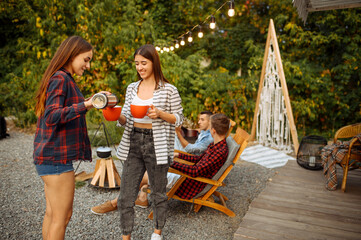 Wall Mural - young friends relax on picnic at camping
