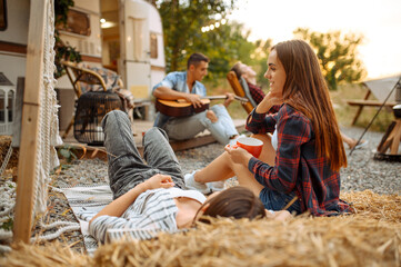 Wall Mural - friends sing songs with guitar, picnic at camping