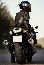 Motorcyclist On His Motorcycle On The Road. Man On A Modern Sport Bike. Freedom And Adventure Concept. Close Up Rear View