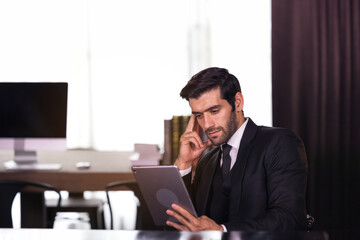 Wall Mural - Young businessman working at home and thinking of something