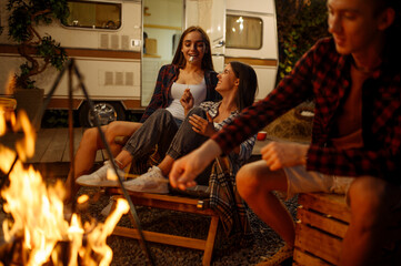 Wall Mural - friends cooking on campfire, picnic at camping