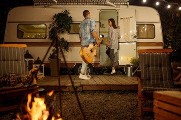 Wall Mural - love couple with guitar, romantic picnic, camping