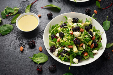 Wall Mural - Blackberry salad with greens, almond nuts, feta, avocado and feta cheese