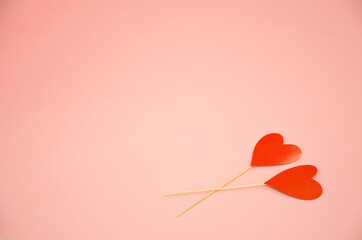 two hearts lie on a pink background. valentine's day concept