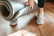 © Gioia - Woman holds yoga mat preparing for home fitness class, sport, acttive lifestyle concept