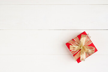 Wall Mural - Red gift box on wooden table background, love and romance, presents in celebration and anniversary with surprise on desk, happy birthday, donate and charity, valentine day 14 February concept.