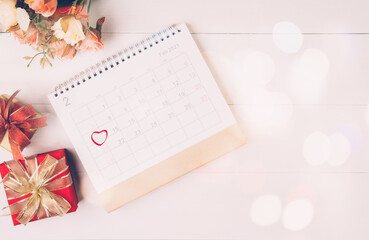 Canvas Print - Calendar and flower with memo 14 February Valentine day on desk with blur bokeh background, reminder for surprise of love, romance and sweet, celebration and decoration, top view, holiday concept.