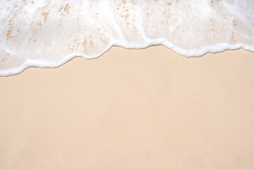 Wall Mural - Soft ocean wave on tropical sandy beach in summer background with copy space