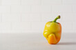 Ugly pepper that looks like a strange face on a light table. Funny, unnormal vegetable or food waste concept.