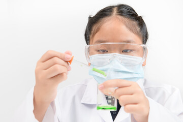 Wall Mural - a little scientist is using a dropper to drop green liquid chemical in beaker isolated