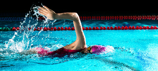 Woman in swimming pool. Crawl swimming style